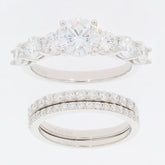 Round white Moissanite sterling silver ring set featuring a sparkling accent piece and elegant design.